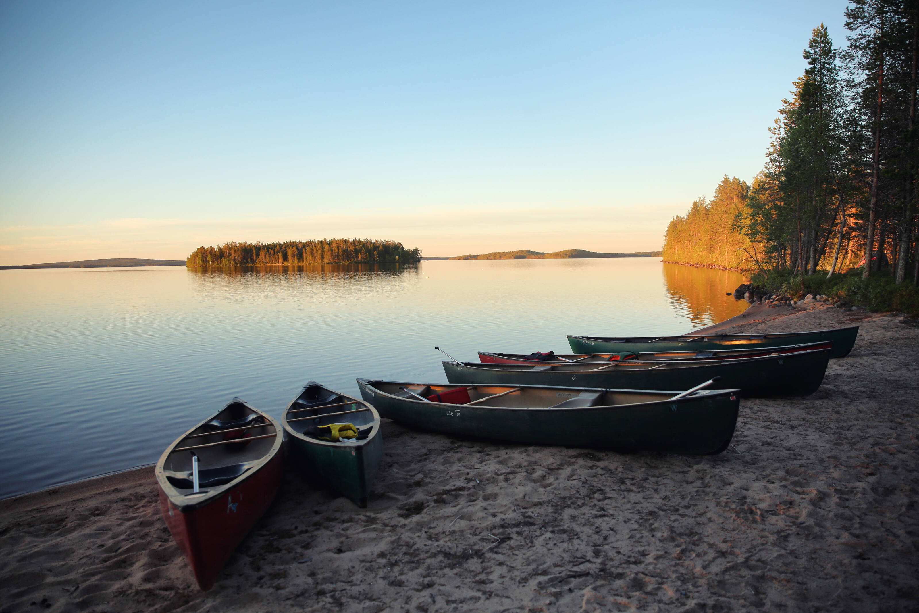 rowing boats lined up on a beach in the Finnish Lapland