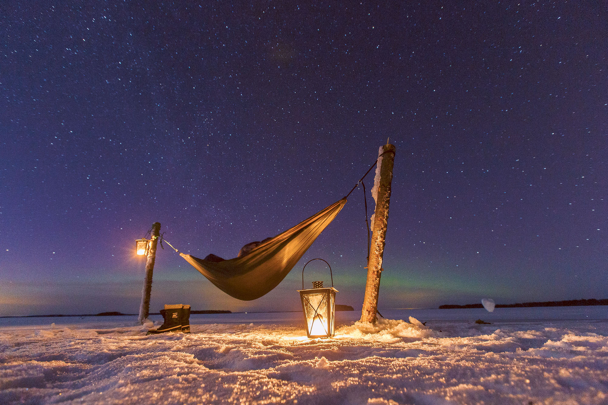 Hammock camp above a frozen lake in Finnish Lakeland.