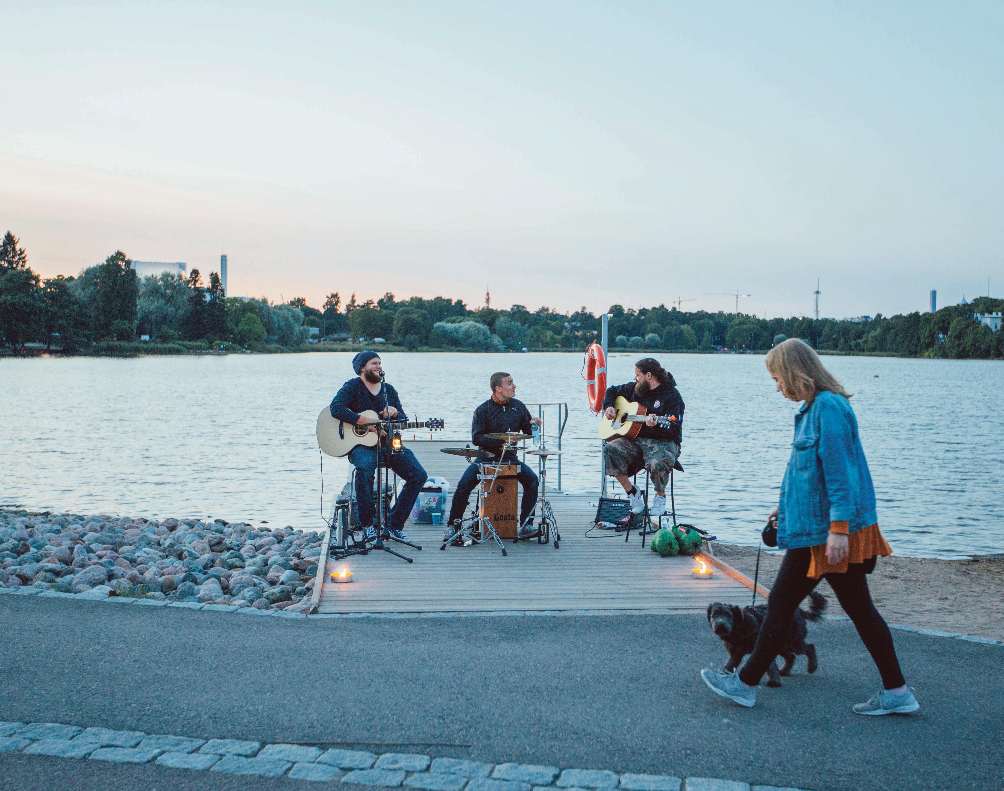 an unplugged band performing in a seaside urban setting