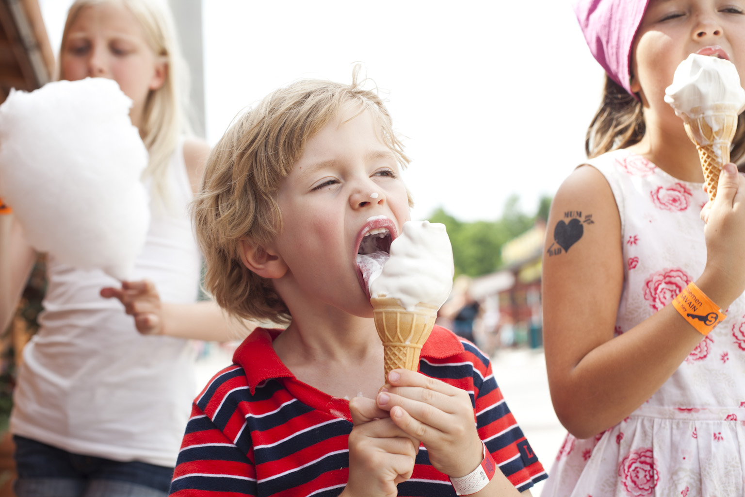 Children eating ice cream and cotton candy