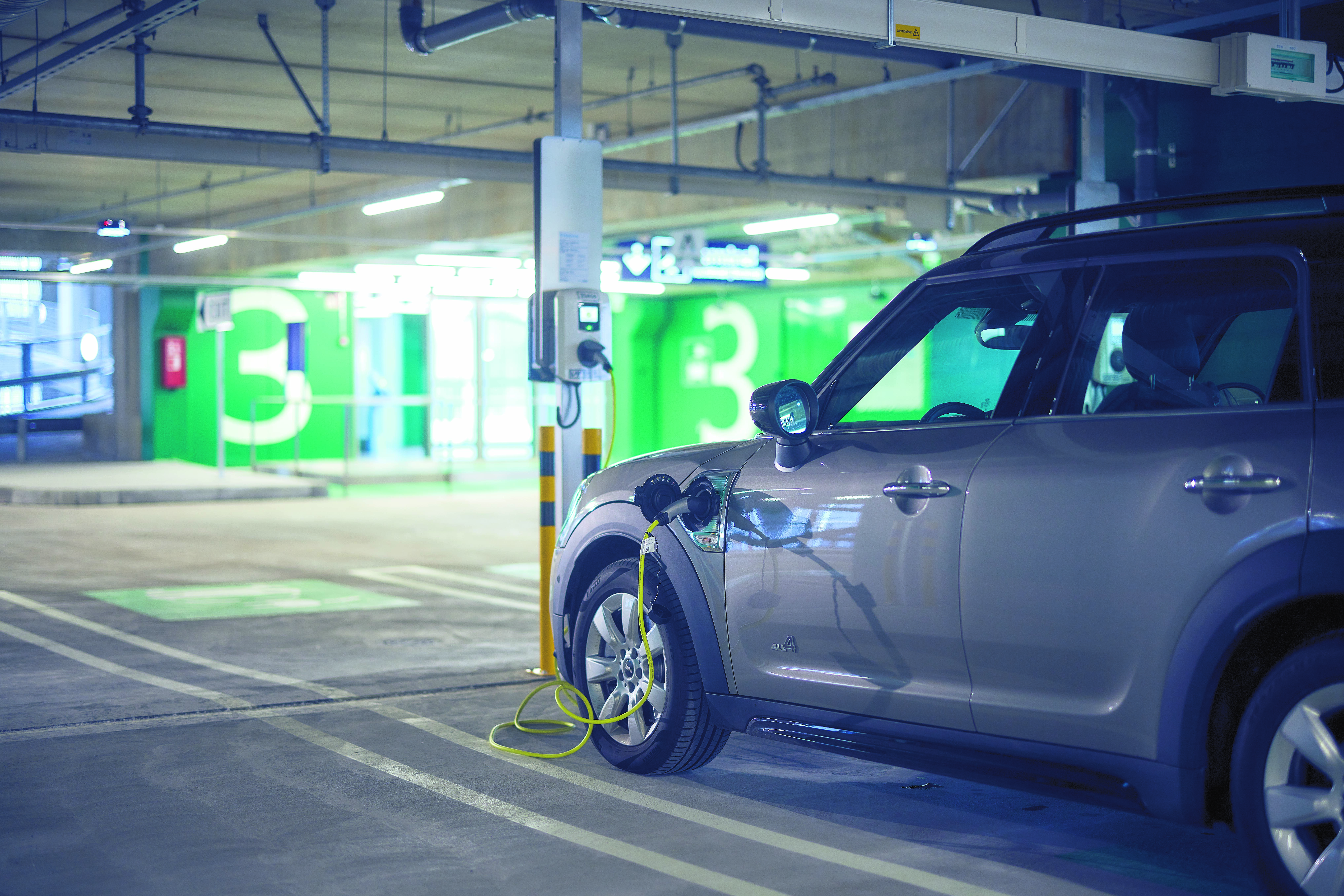 An electric car charging in the parking hall in Helsinki-Vantaa airport.