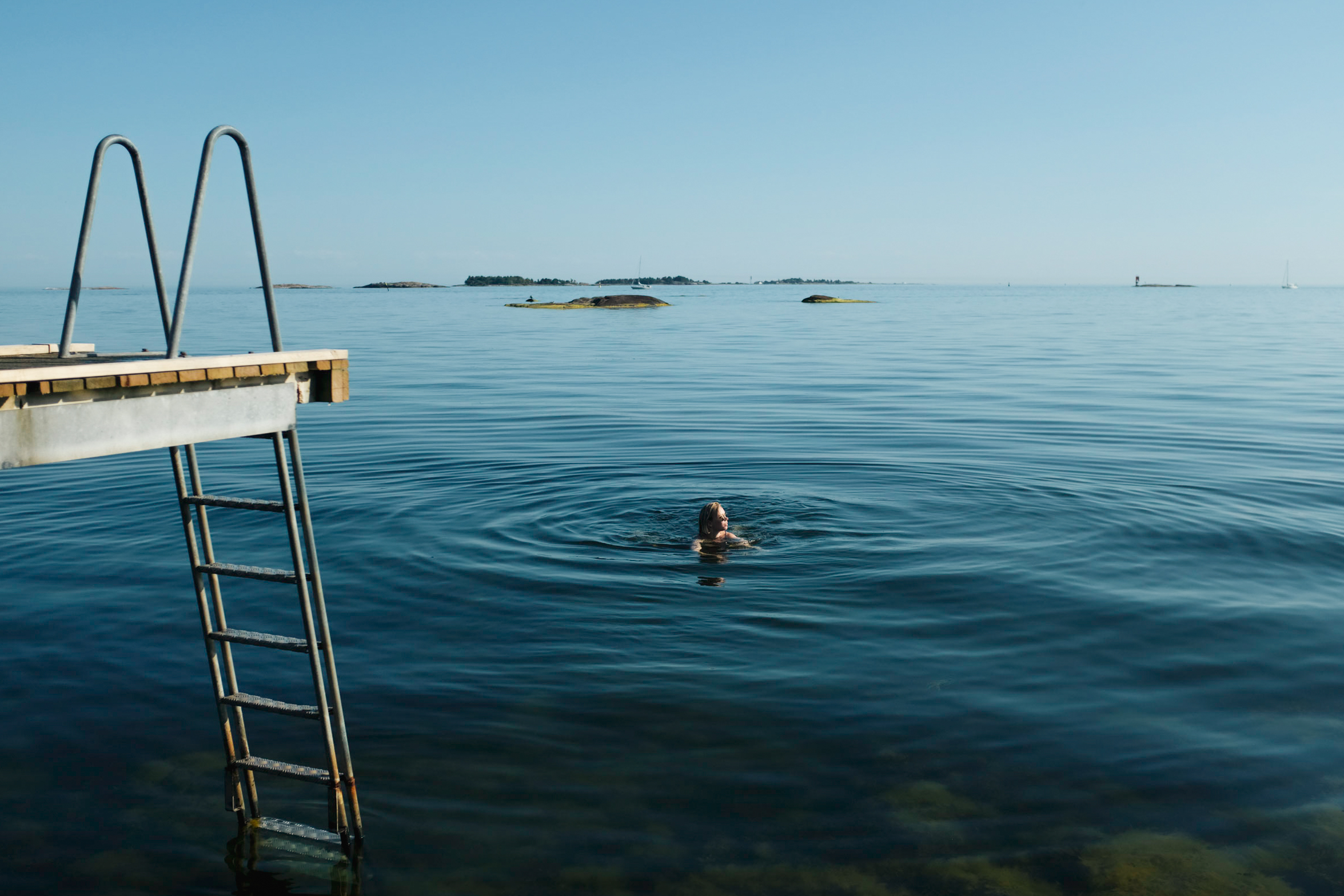 a woman swimming in the Baltic sea in the coast of Helsinki