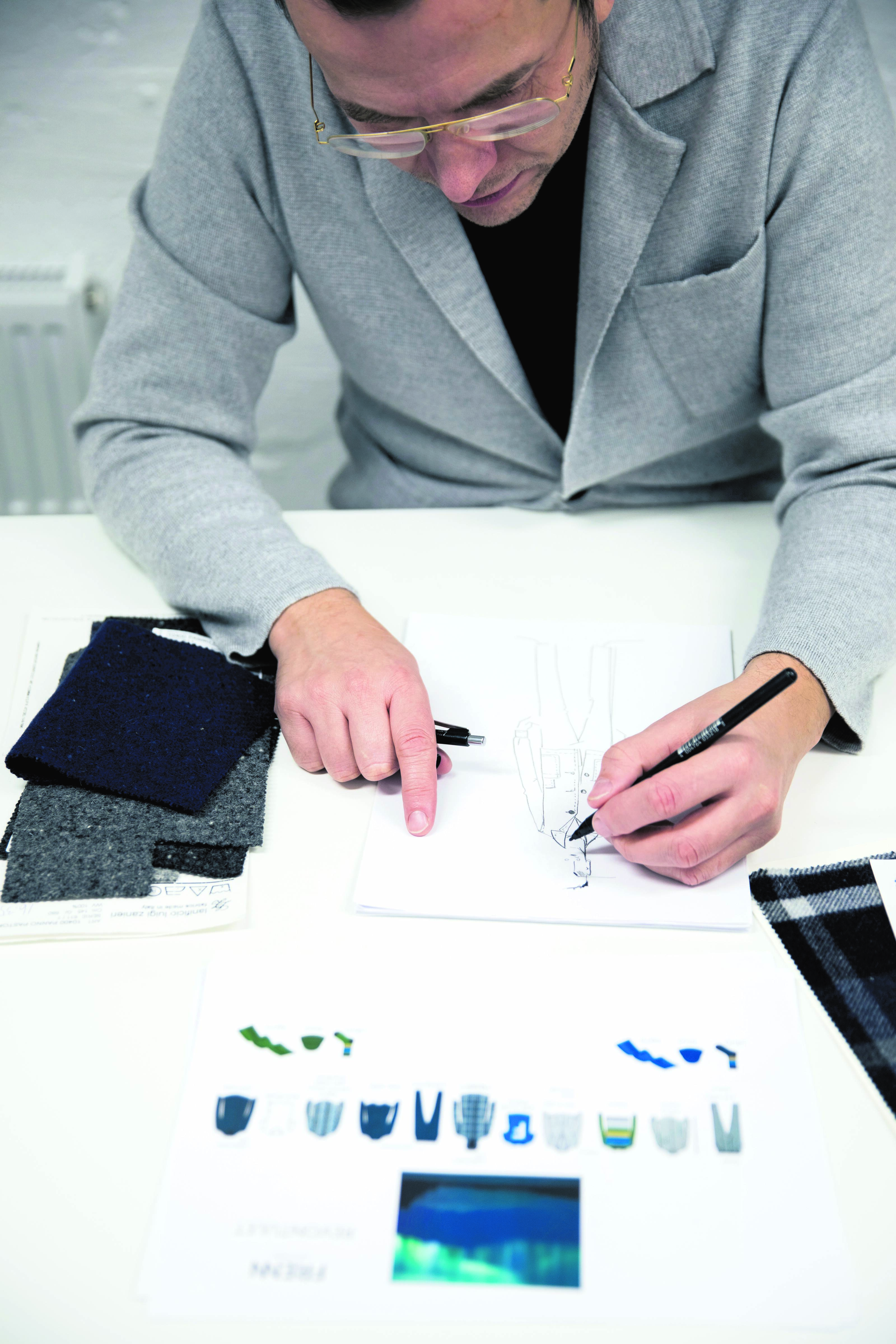 Designer outlines the garment on paper