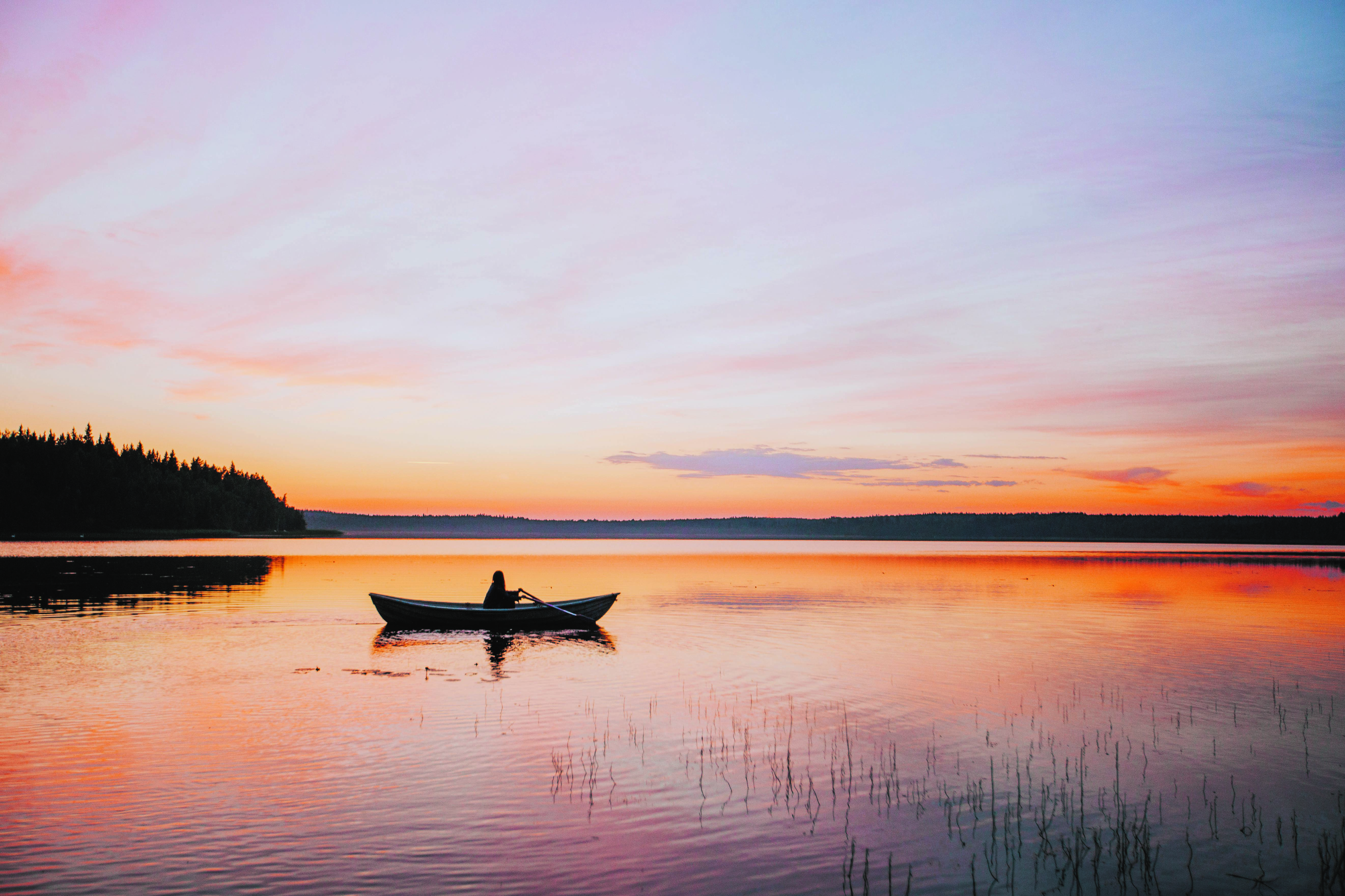 a person rowing a boat under the Midnight Sun