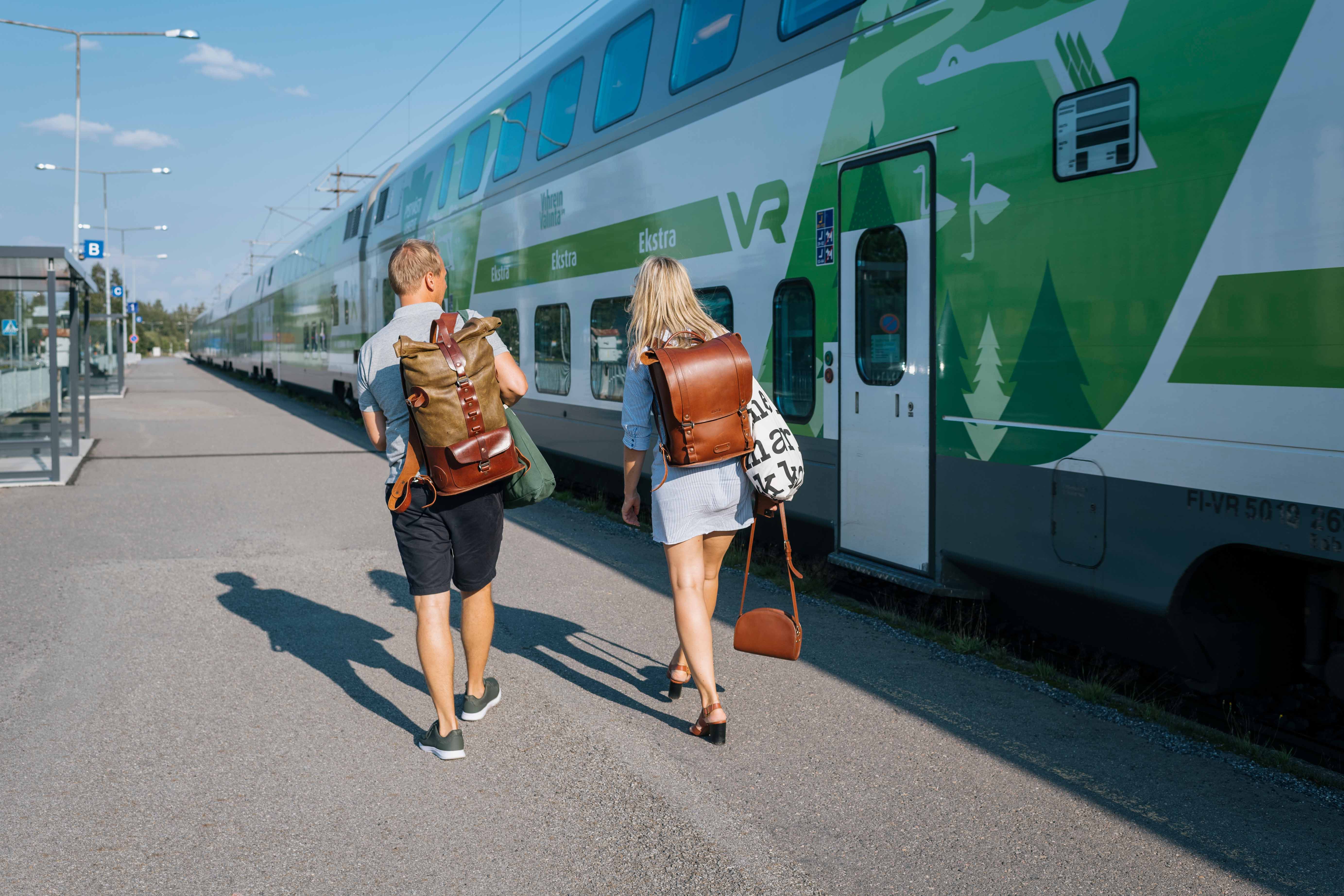 people getting on a train in Kokkola, Finland