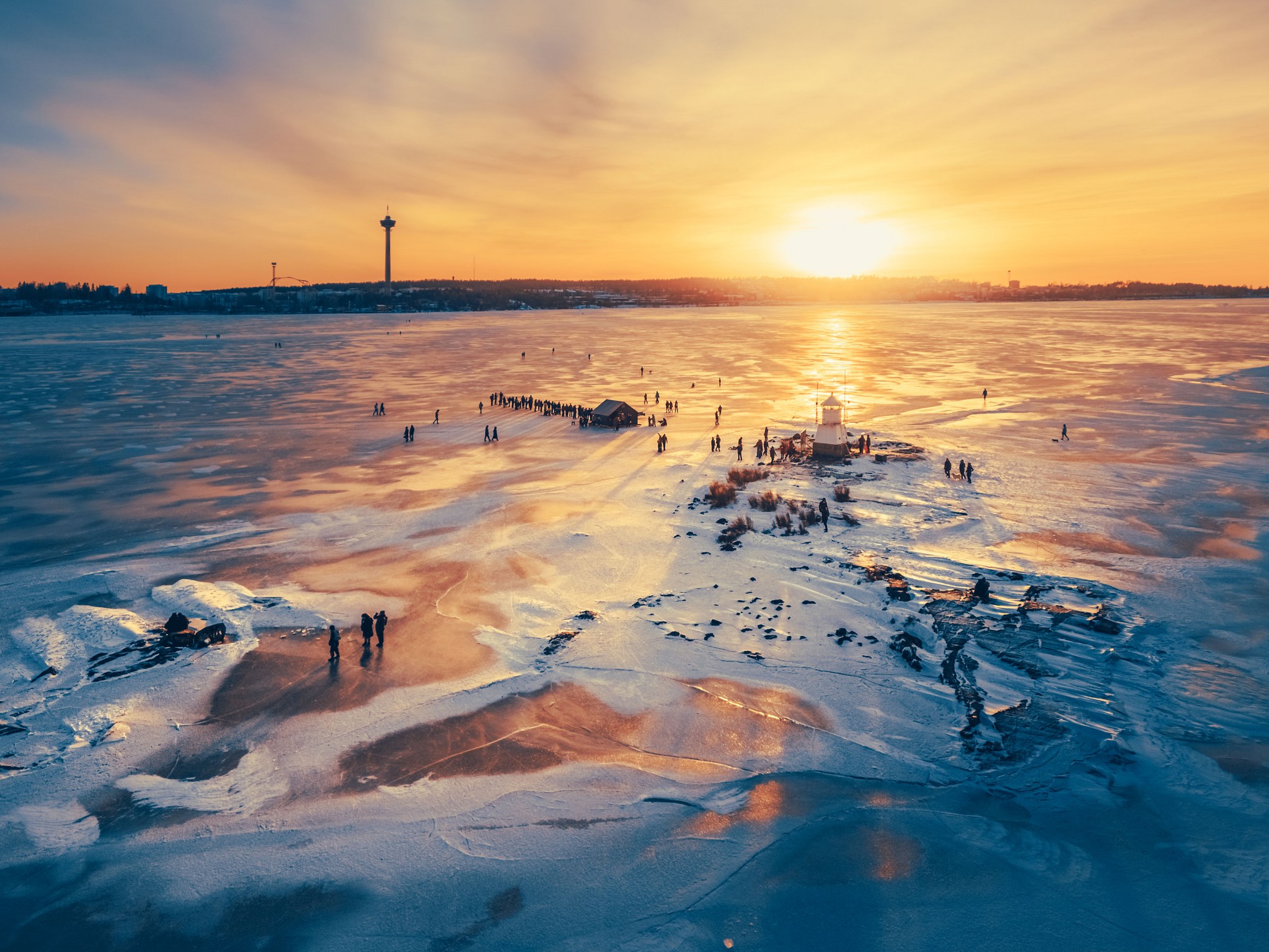 Sun setting over a frozen lake in Tampere, Finland.