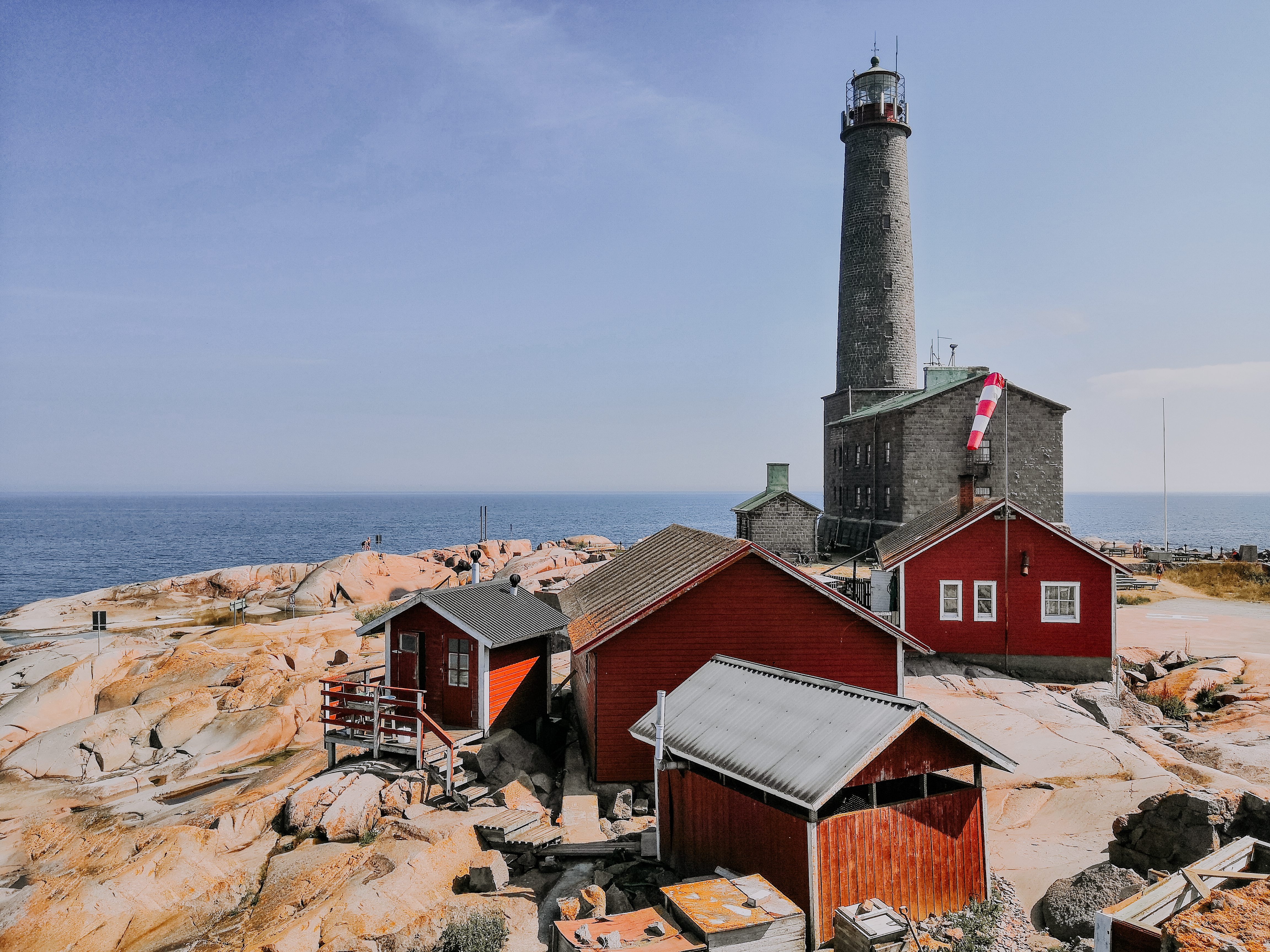 a huge traditional lighthouse on a cliff