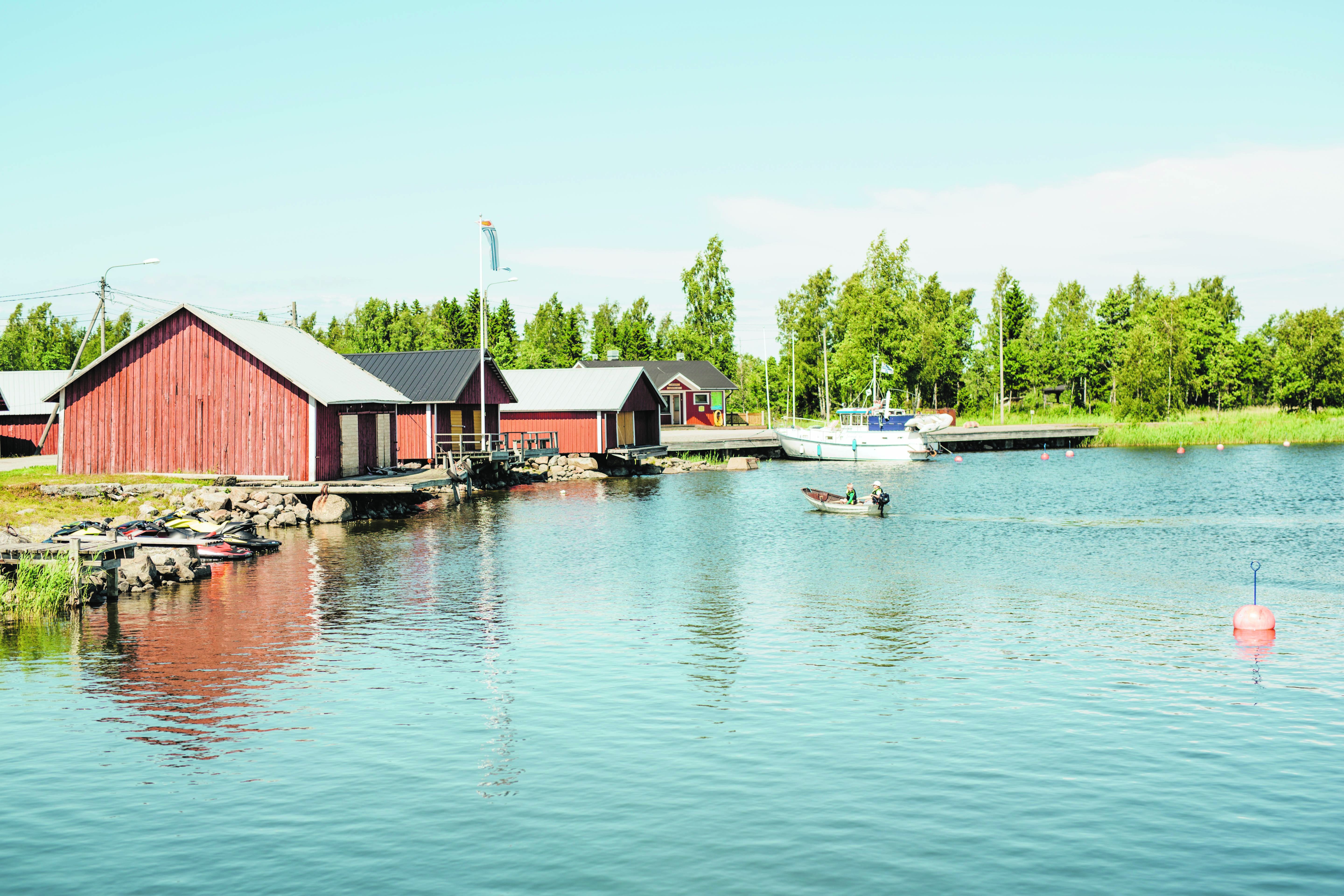 Red houses by the sea in Finnish countryside