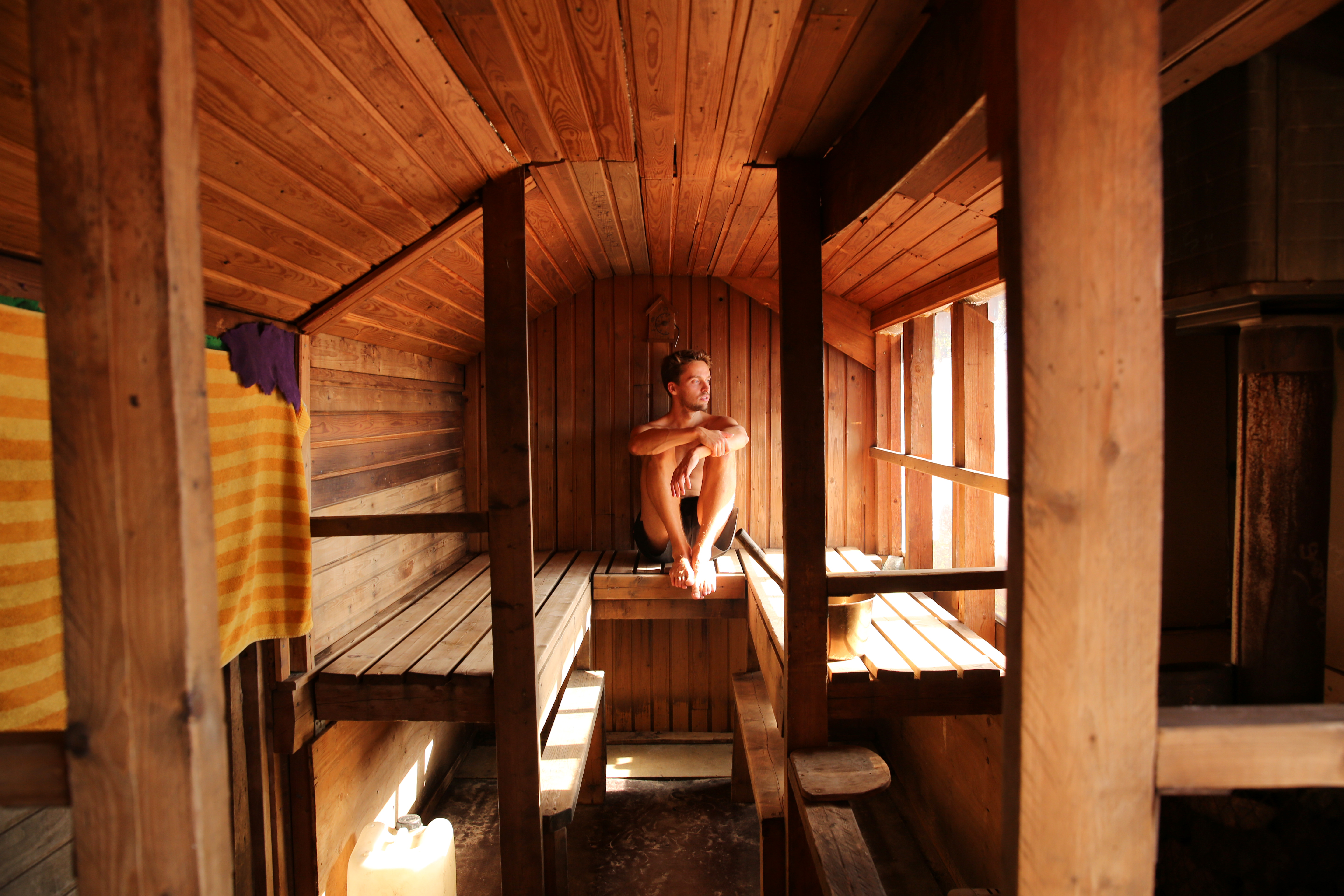 a man sits in a sauna and enjoys a steam bath