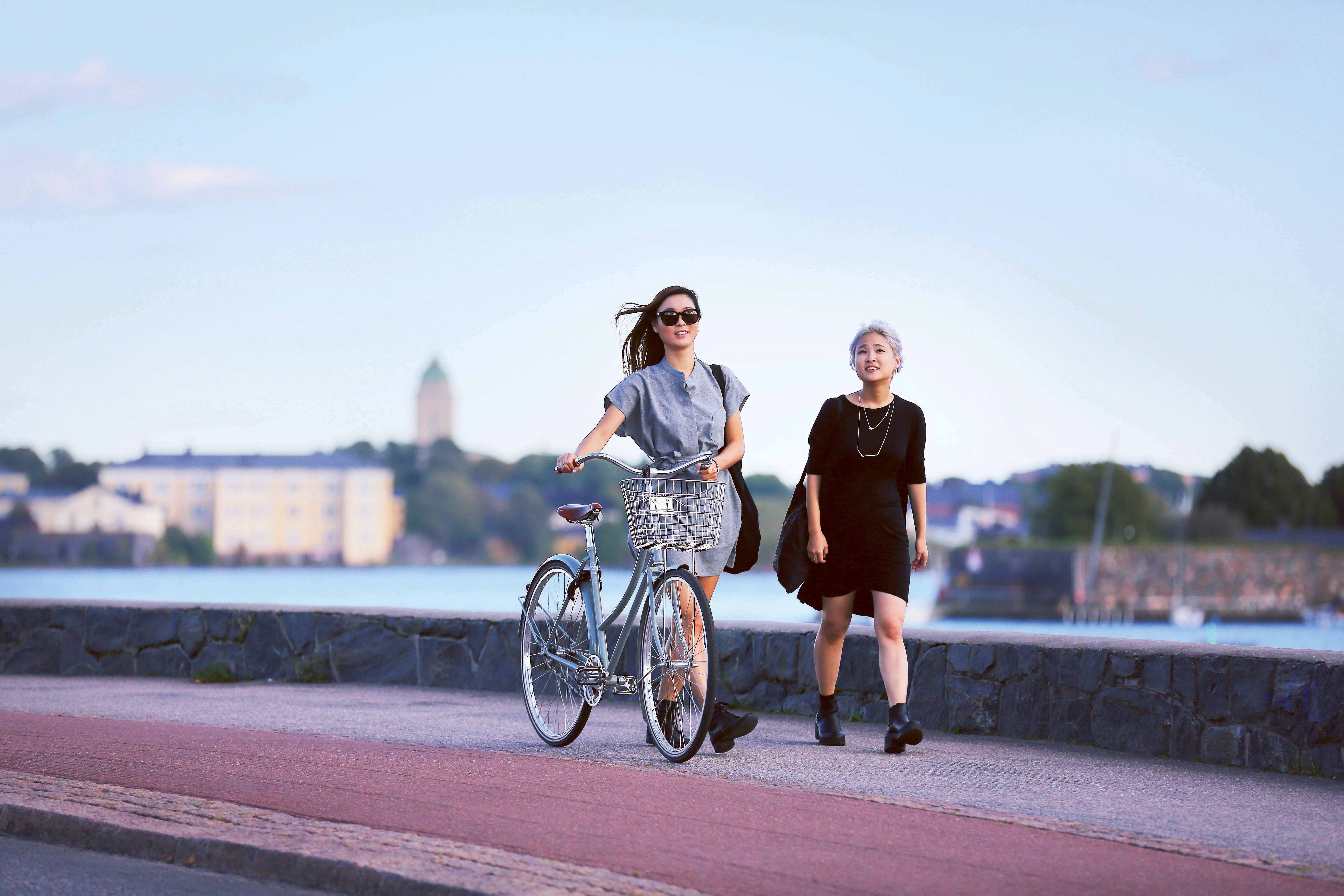 Two people walking by the Baltic sea in urban Helsinki