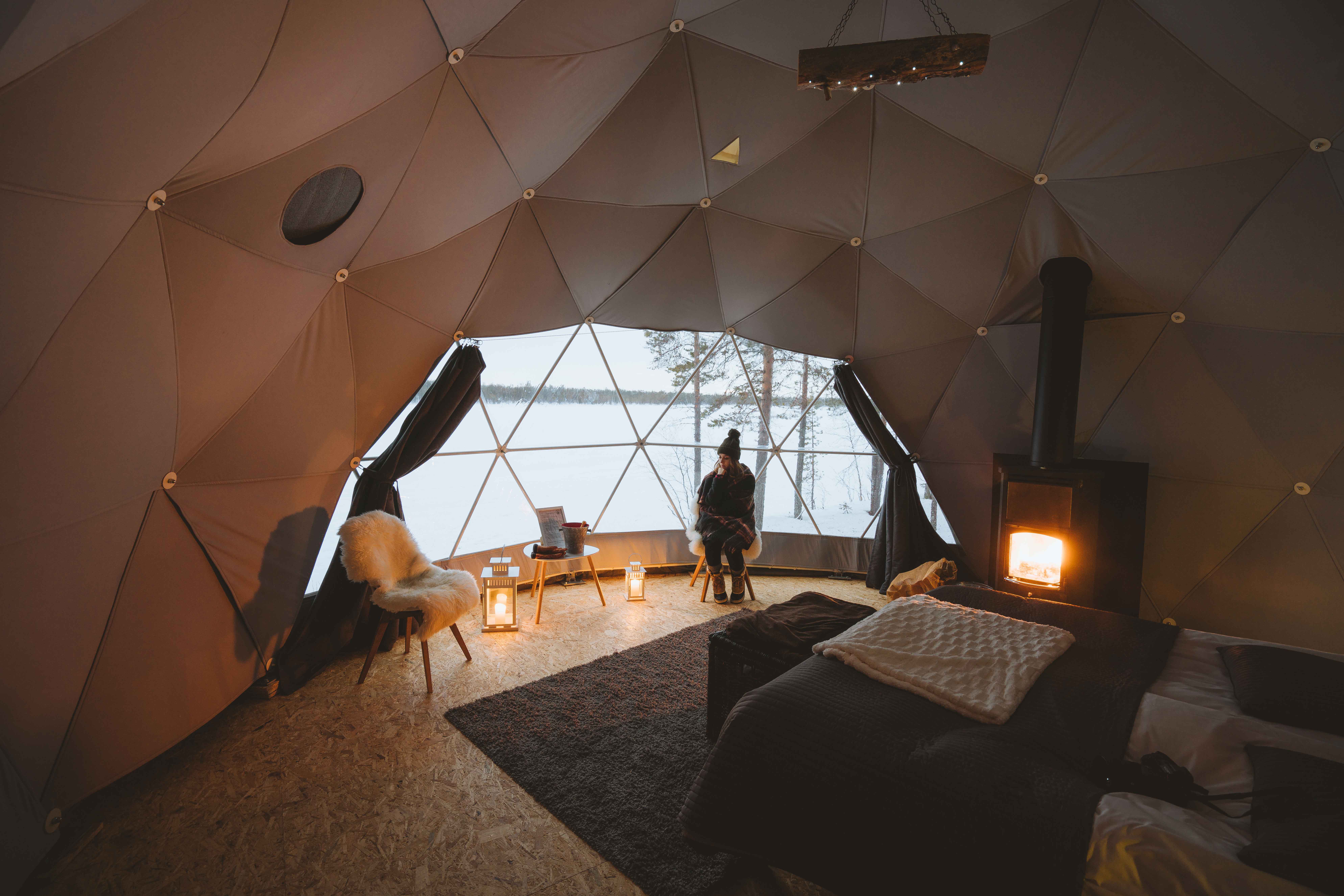 The interior of a round hut-like tent with Lappish-themed decor