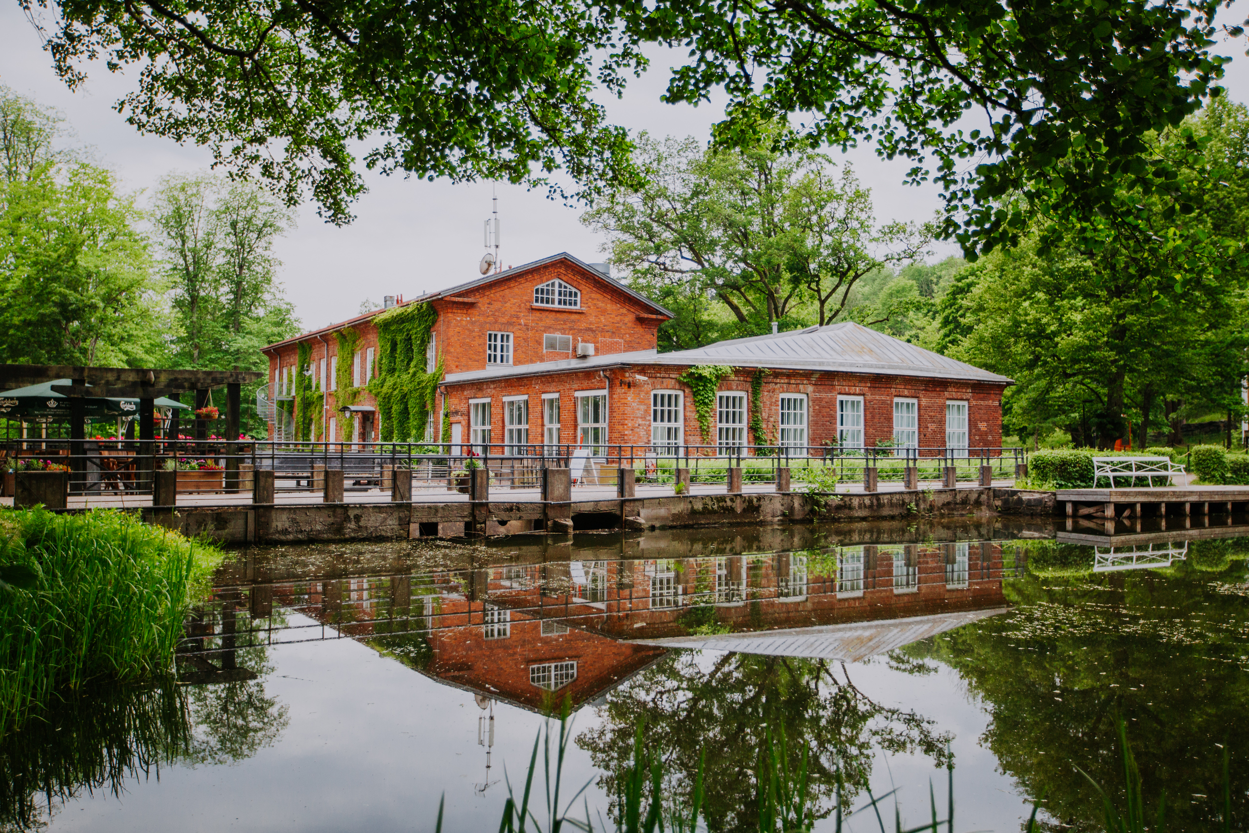 an ironworks building made of well-burned bricks next to a Fiskars river