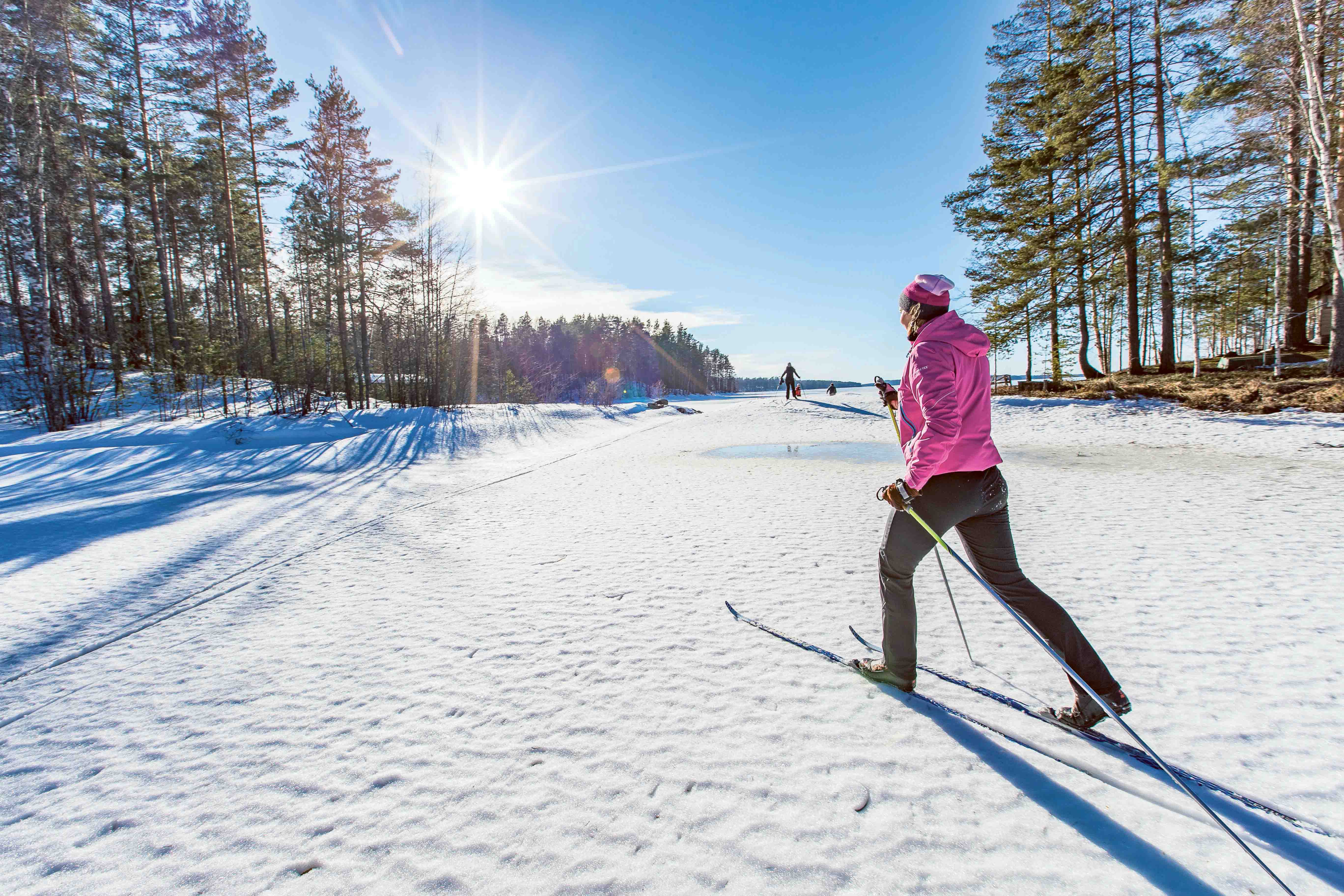 woman skiing on lake ice while the sun is shining